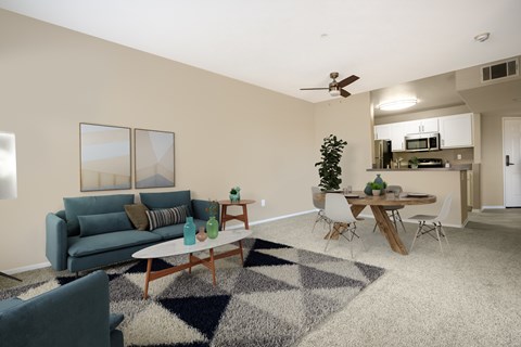 a living room with a couch and a table and a kitchen